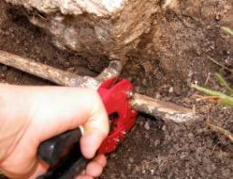 El Cerrito sprinkler repair professional cuts and removes a sprinkler pipe