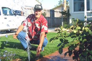 a Richmond Sprinkler Repair tech works on a broken pop up head